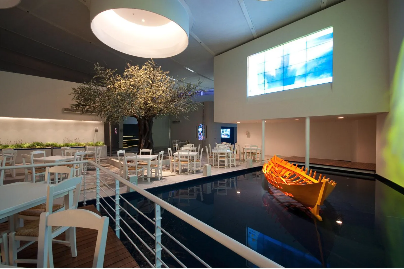 Café with a traditional boat on the water